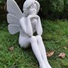 Statue of a fairy sat in thought.