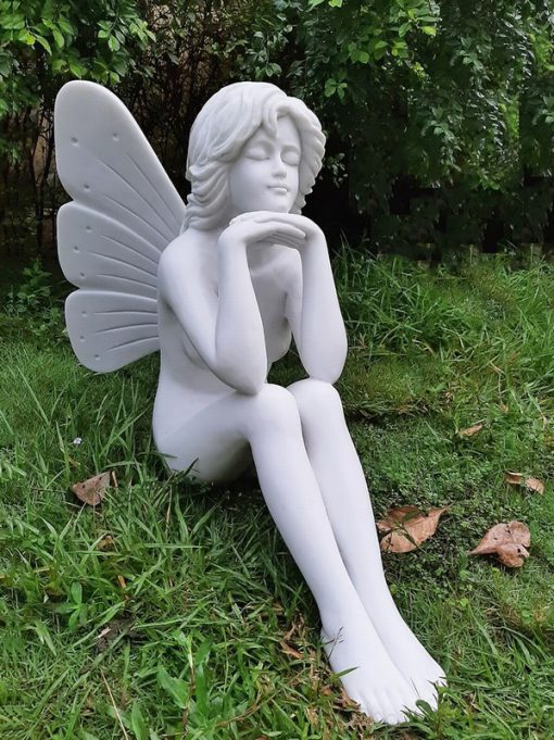Statue of a fairy sat in thought.