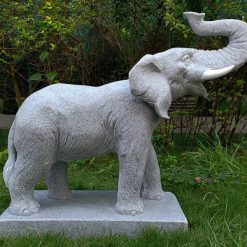 Granite effect statue of an Elephant atop a stone plinth.