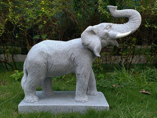 Granite effect statue of an Elephant atop a stone plinth.
