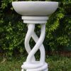 Ornate bird bath with a marble finish.