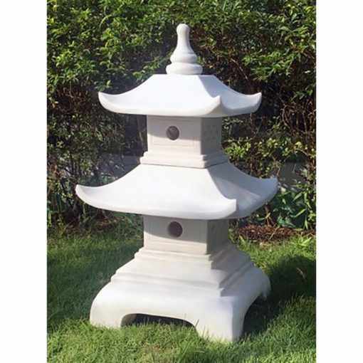 a two tier Pagoda ornament, resting on a neat lawn.